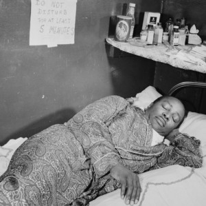 Young B.B. King posing with an acoustic guitar marked with WDIA lettering.