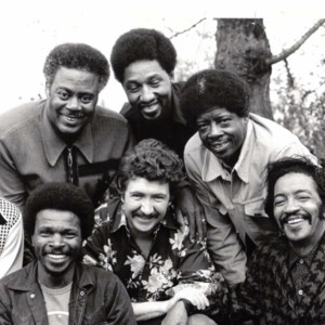 Group photo of the Chicago Blues All-Stars posing outdoors together.